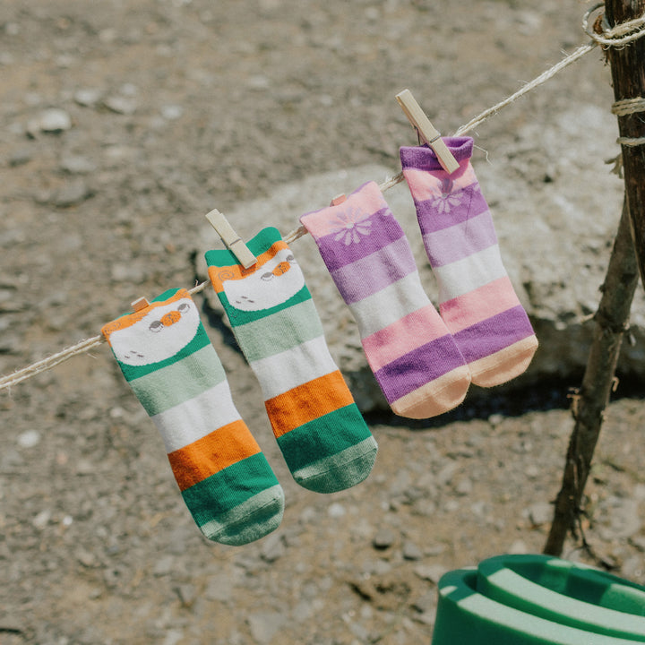 GREEN SOCKS WITH STRIPES AND A PUPPY, BABY