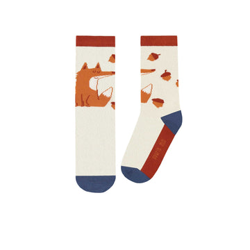 Burnt orange socks with foxes and hazelnuts, child